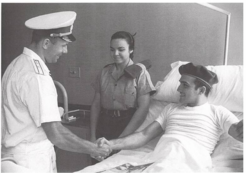 Юрий Гагарин беседует с раненным на ПлайяХирон. Фото В.Соболев, из альбома «Непобедимые-3»