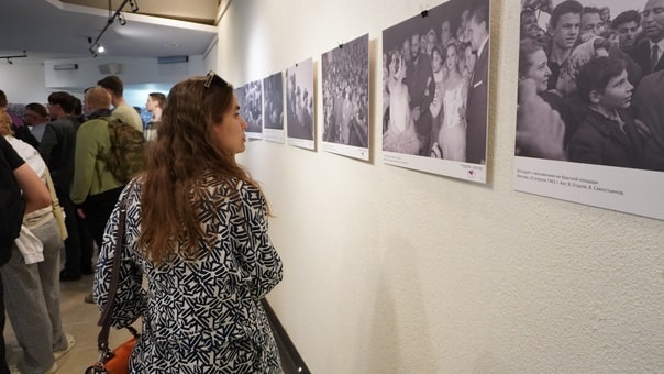 Женщина рассматривает фотографию Фиделя Кастро на стенке